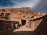 Traditional entrance to the ancient ksar of Ait Ben Haddou, Morocco, showing earthen architecture and fortified walls.