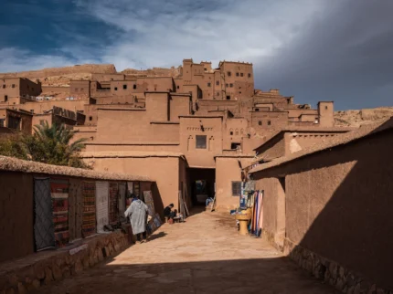Traditional entrance to the ancient ksar of Ait Ben Haddou, Morocco, showing earthen architecture and fortified walls.