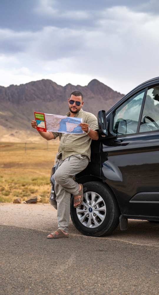 Personal driver standing beside a rental car in Morocco, ready for a private tour